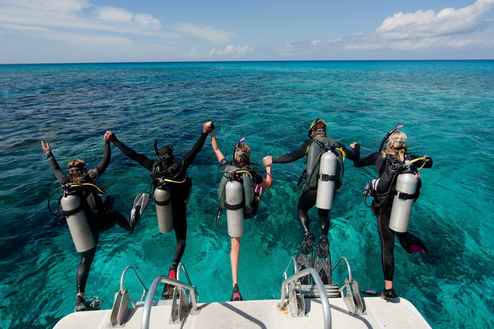 scuba-divers-enter-water-from-boat-via-giant-stride-entry-diving-into-the-water- Diving on the beach - Image 1